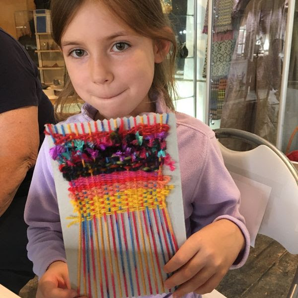 Young visitor with weaving project